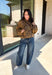 Give your fall layers a little personality with this brown animal print jacket from Entro. The neutral color palette makes the statement print surprisingly easy to mix into your everyday wardrobe, whether you're heading to lunch, running errands, or spending a Saturday out and about. A zipper closure keeps the silhouette casual, while the tie detail at the neckline adds a fun finishing touch.