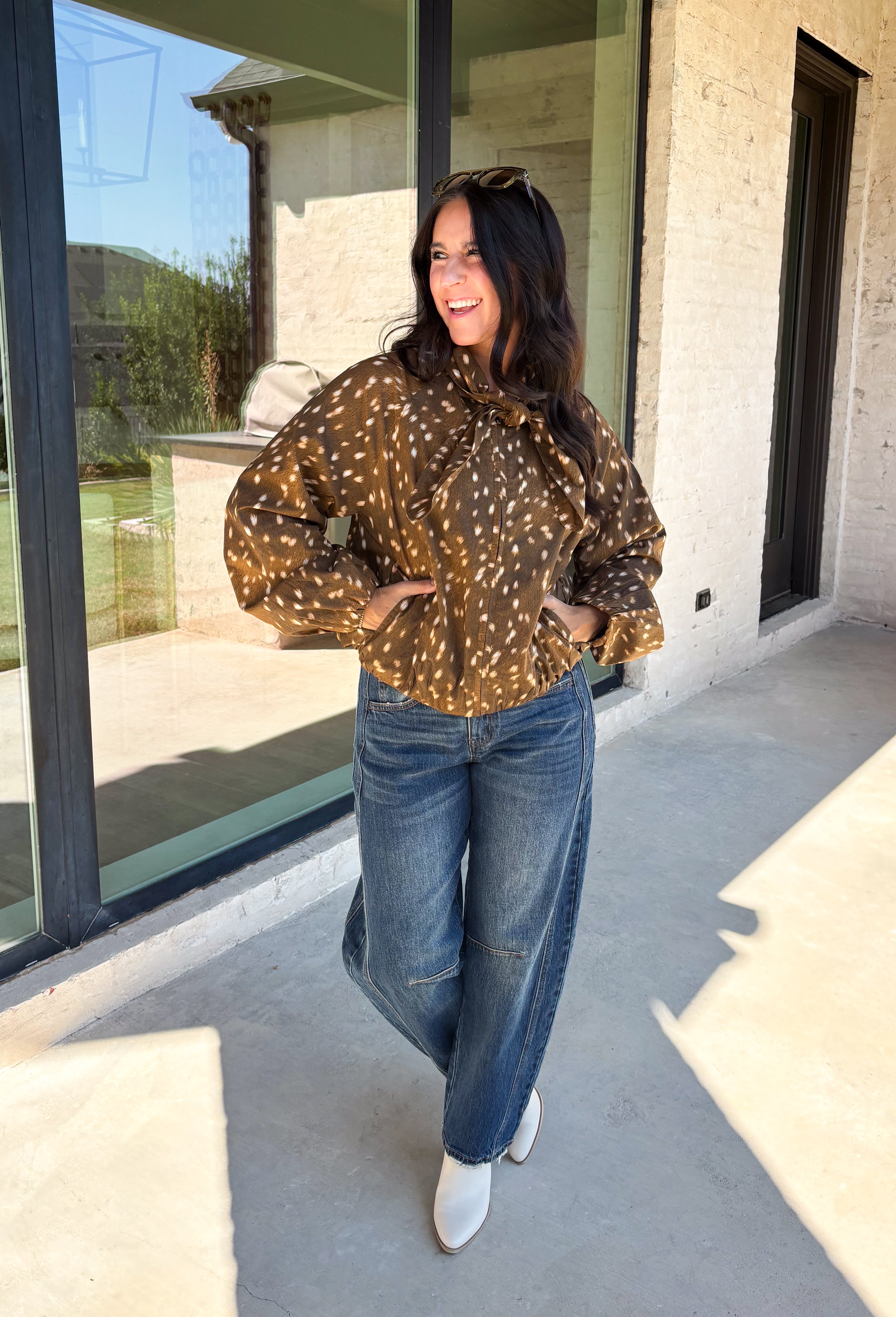 Give your fall layers a little personality with this brown animal print jacket from Entro. The neutral color palette makes the statement print surprisingly easy to mix into your everyday wardrobe, whether you're heading to lunch, running errands, or spending a Saturday out and about. A zipper closure keeps the silhouette casual, while the tie detail at the neckline adds a fun finishing touch.