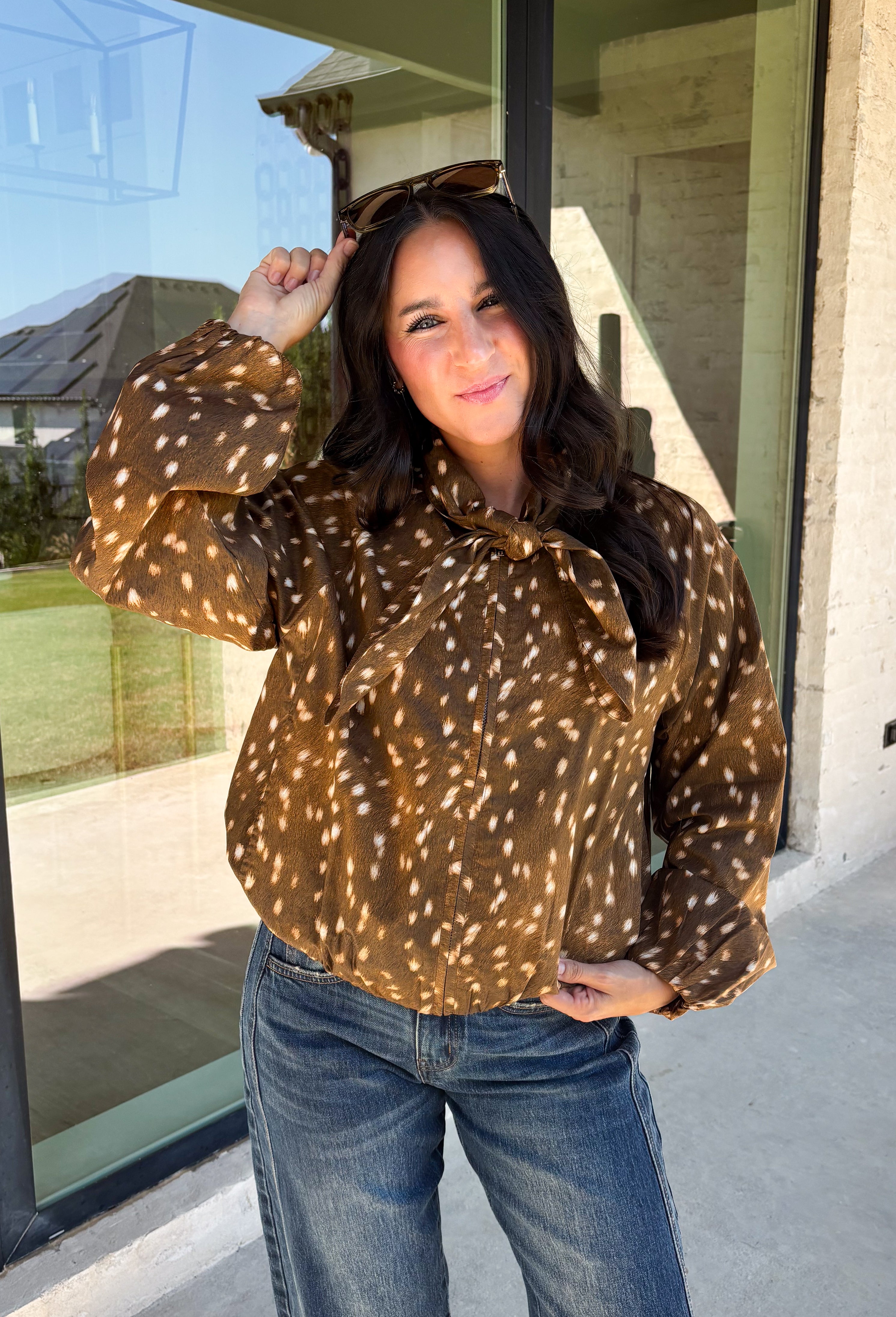 Give your fall layers a little personality with this brown animal print jacket from Entro. The neutral color palette makes the statement print surprisingly easy to mix into your everyday wardrobe, whether you're heading to lunch, running errands, or spending a Saturday out and about. A zipper closure keeps the silhouette casual, while the tie detail at the neckline adds a fun finishing touch.