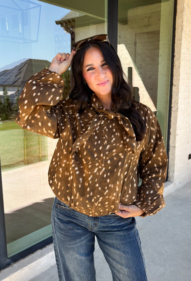 Give your fall layers a little personality with this brown animal print jacket from Entro. The neutral color palette makes the statement print surprisingly easy to mix into your everyday wardrobe, whether you're heading to lunch, running errands, or spending a Saturday out and about. A zipper closure keeps the silhouette casual, while the tie detail at the neckline adds a fun finishing touch.