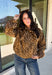 Give your fall layers a little personality with this brown animal print jacket from Entro. The neutral color palette makes the statement print surprisingly easy to mix into your everyday wardrobe, whether you're heading to lunch, running errands, or spending a Saturday out and about. A zipper closure keeps the silhouette casual, while the tie detail at the neckline adds a fun finishing touch.