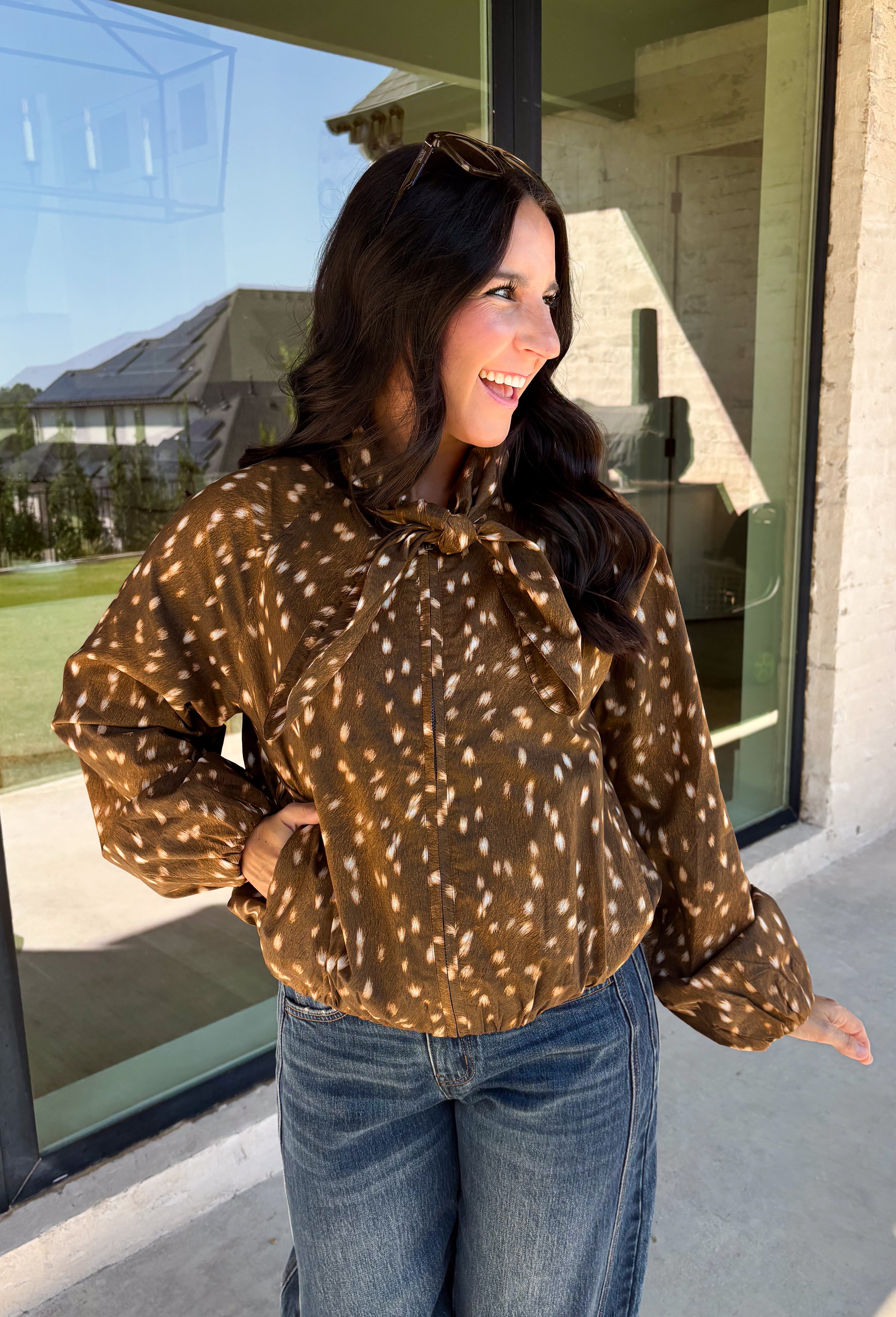 Give your fall layers a little personality with this brown animal print jacket from Entro. The neutral color palette makes the statement print surprisingly easy to mix into your everyday wardrobe, whether you're heading to lunch, running errands, or spending a Saturday out and about. A zipper closure keeps the silhouette casual, while the tie detail at the neckline adds a fun finishing touch.