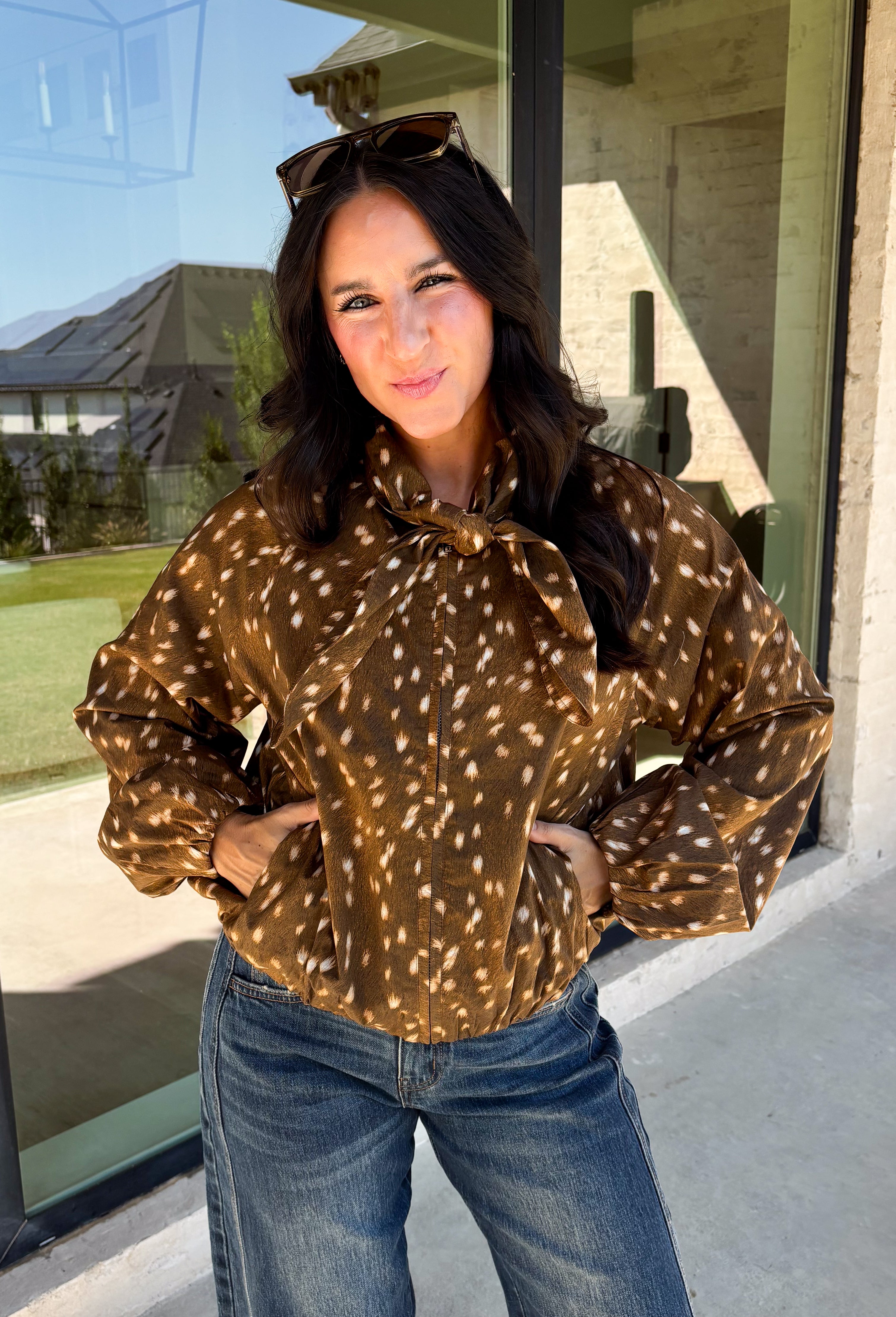 Give your fall layers a little personality with this brown animal print jacket from Entro. The neutral color palette makes the statement print surprisingly easy to mix into your everyday wardrobe, whether you're heading to lunch, running errands, or spending a Saturday out and about. A zipper closure keeps the silhouette casual, while the tie detail at the neckline adds a fun finishing touch.