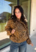 Give your fall layers a little personality with this brown animal print jacket from Entro. The neutral color palette makes the statement print surprisingly easy to mix into your everyday wardrobe, whether you're heading to lunch, running errands, or spending a Saturday out and about. A zipper closure keeps the silhouette casual, while the tie detail at the neckline adds a fun finishing touch.