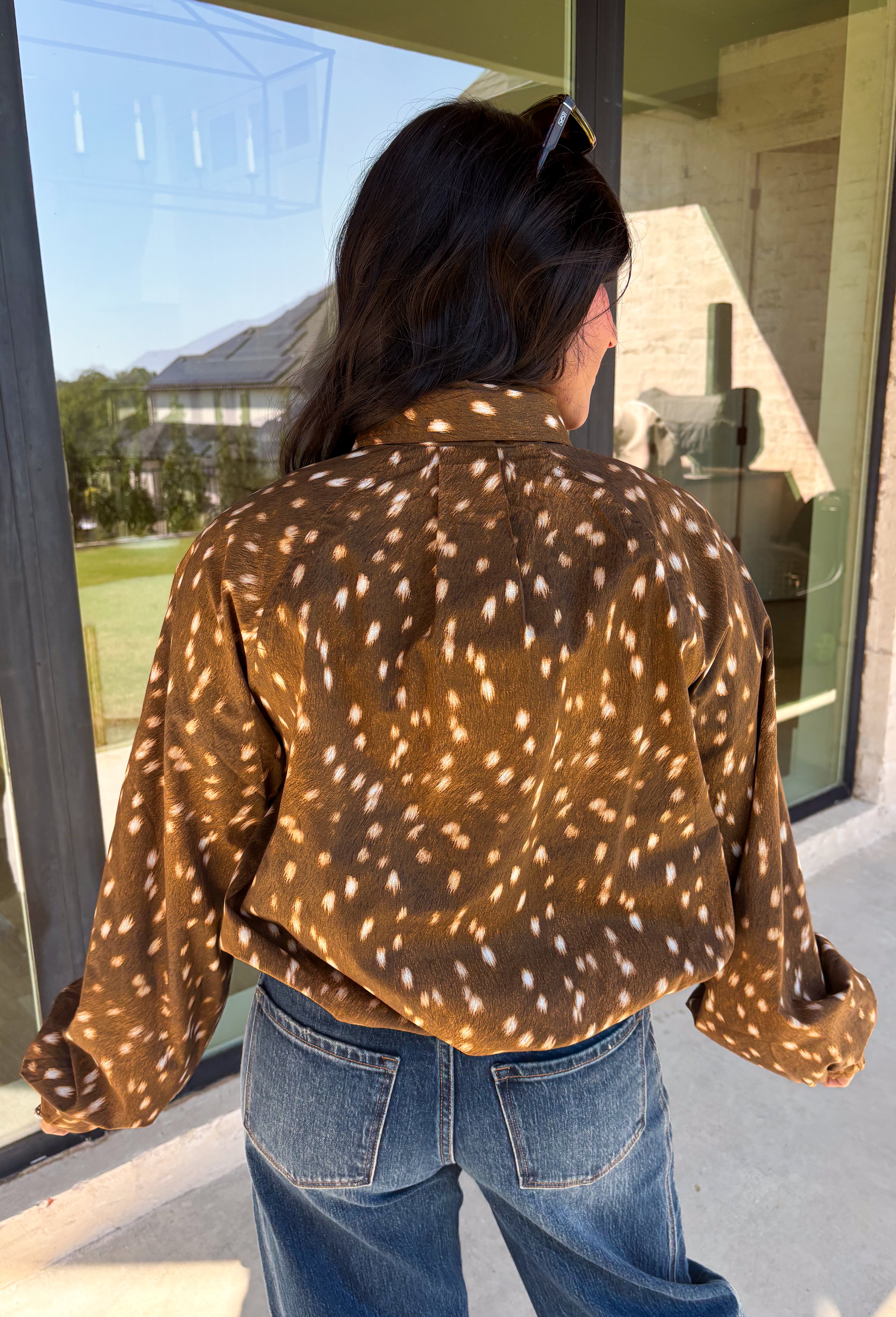 Give your fall layers a little personality with this brown animal print jacket from Entro. The neutral color palette makes the statement print surprisingly easy to mix into your everyday wardrobe, whether you're heading to lunch, running errands, or spending a Saturday out and about. A zipper closure keeps the silhouette casual, while the tie detail at the neckline adds a fun finishing touch.