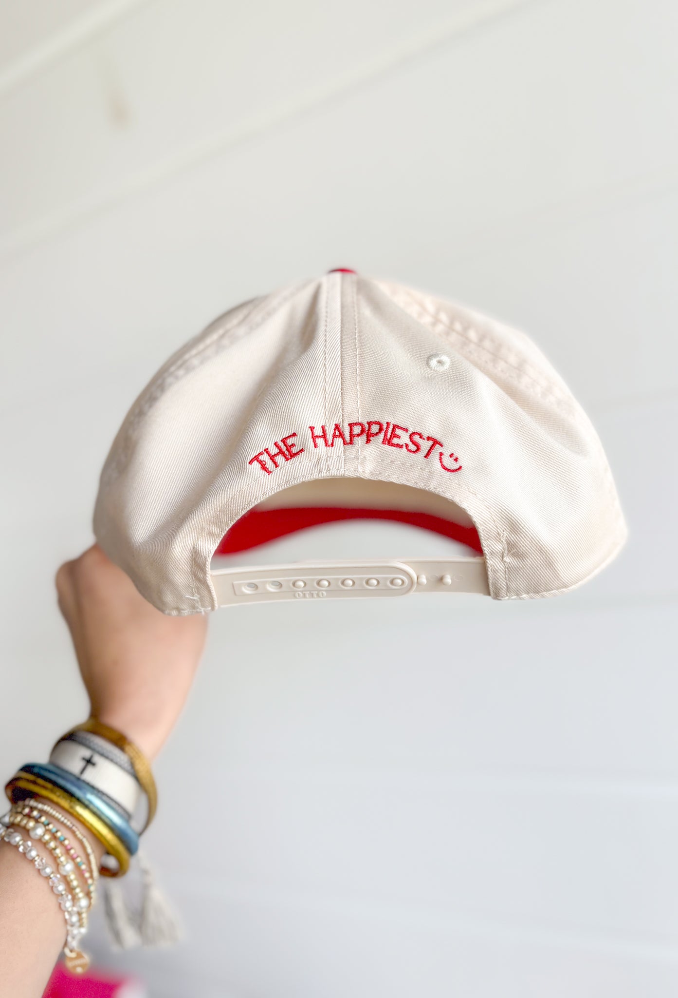 The Dirtier The Better Trucker Hat, red and cream trucker hat with red embroidered text "the dirtier the better" with a hand holding a martini in the center 