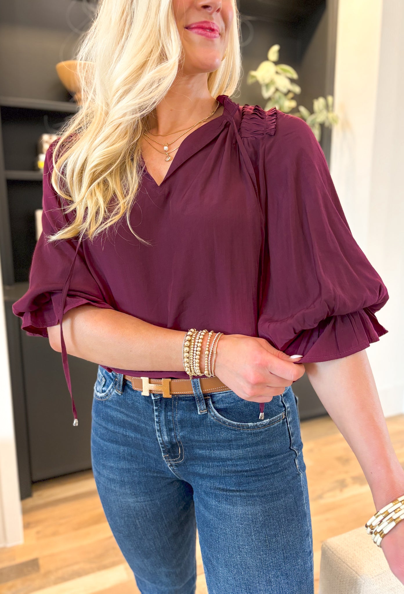 Best Effort Blouse in Merlot, quarter sleeve blouse with ruffle detail around the neck and on the shoulders, v-neck line, ruffling on the bottom of the sleeves 