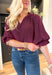 Best Effort Blouse in Merlot, quarter sleeve blouse with ruffle detail around the neck and on the shoulders, v-neck line, ruffling on the bottom of the sleeves 