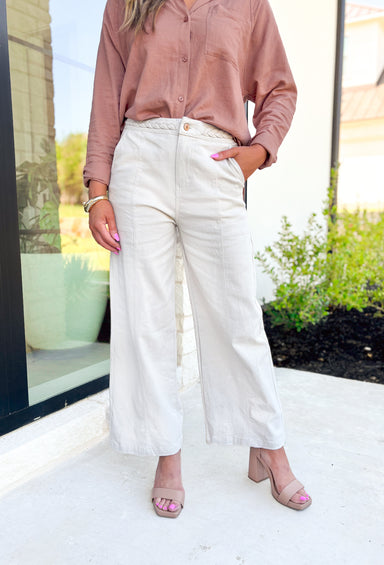 Bridget Wide Leg Pants in Sand, cream wide leg pant with braided detail on the waist, large pockets, and seam down the front, side and back of the leg