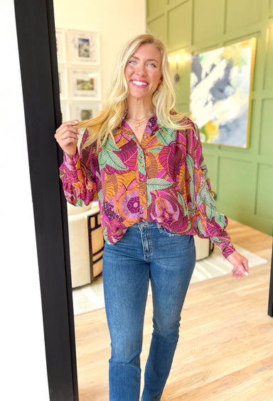 By Your Side Blouse, long sleeve button down blouse with abstract palm leaves in the colors burnt orange, sage green, magenta, deep plum, lilac, pink, cognac, and mustard, zipper detail on the wrists to make them fitted