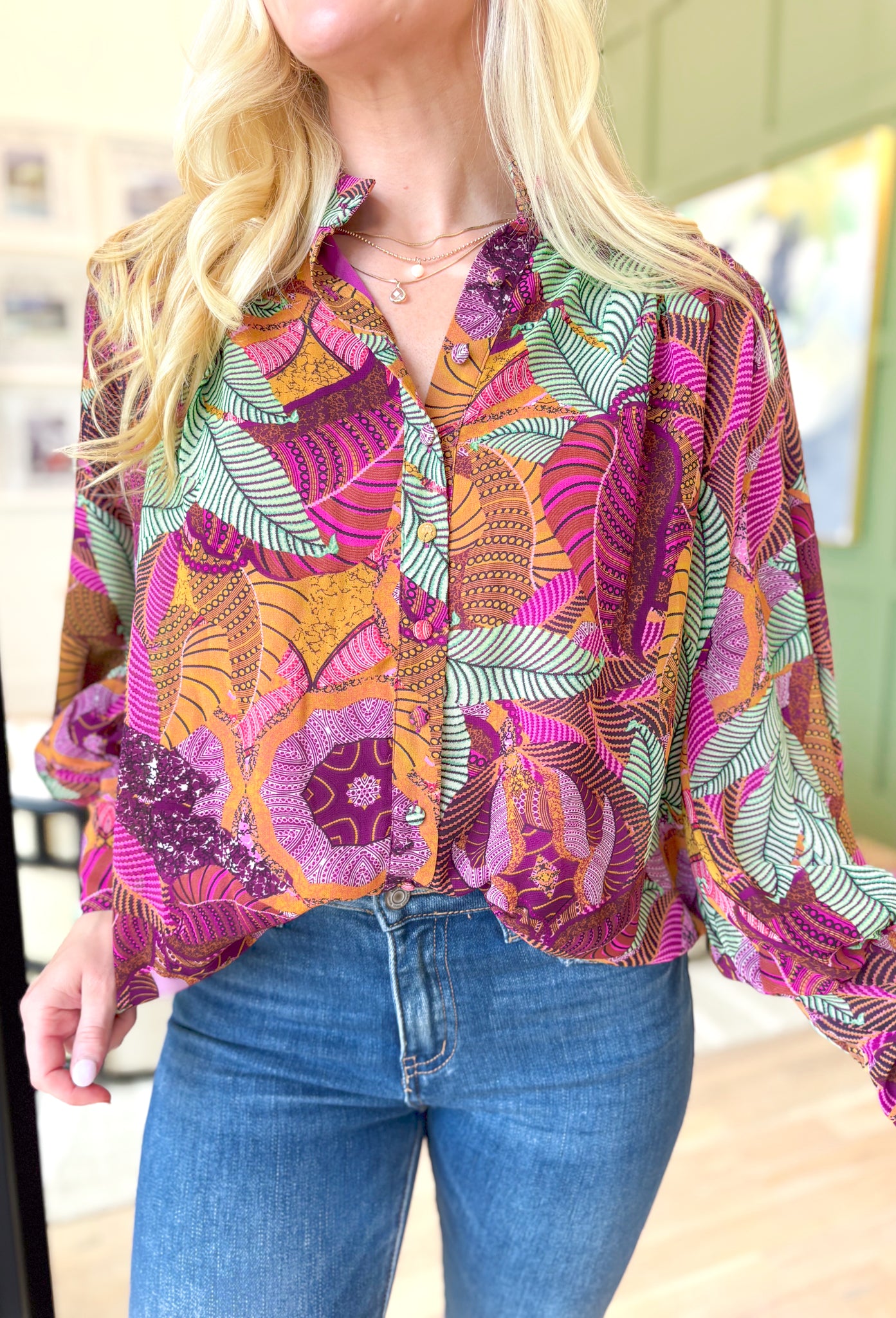 By Your Side Blouse, long sleeve button down blouse with abstract palm leaves in the colors burnt orange, sage green, magenta, deep plum, lilac, pink, cognac, and mustard, zipper detail on the wrists to make them fitted