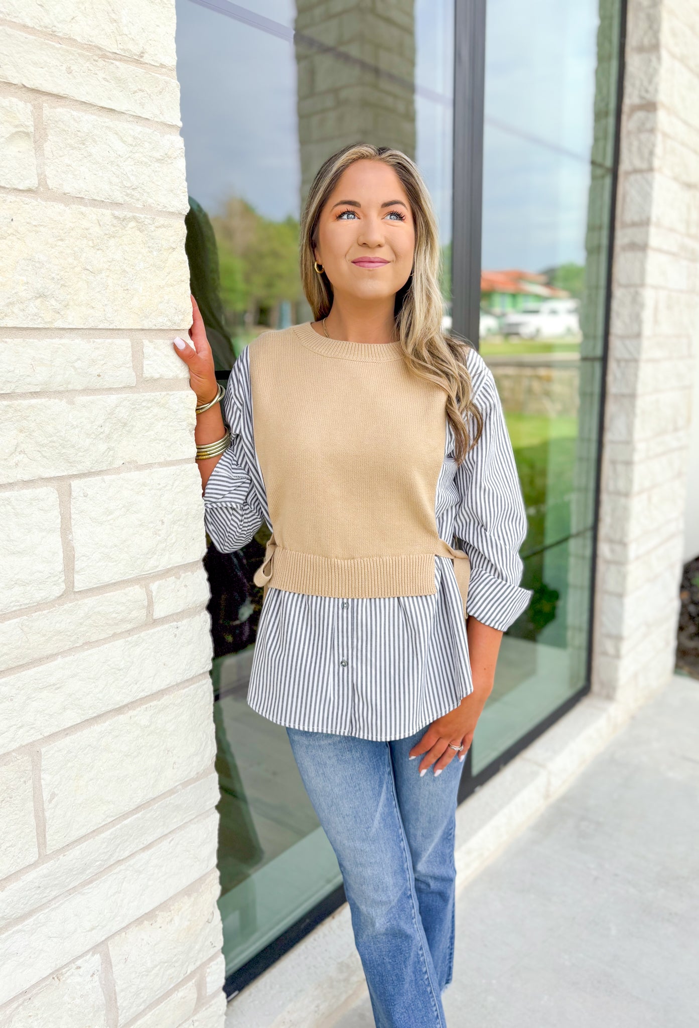 Care To Be Classic Top, grey and white pinstripe button down with camel sweater layered on top, tie details on the side 