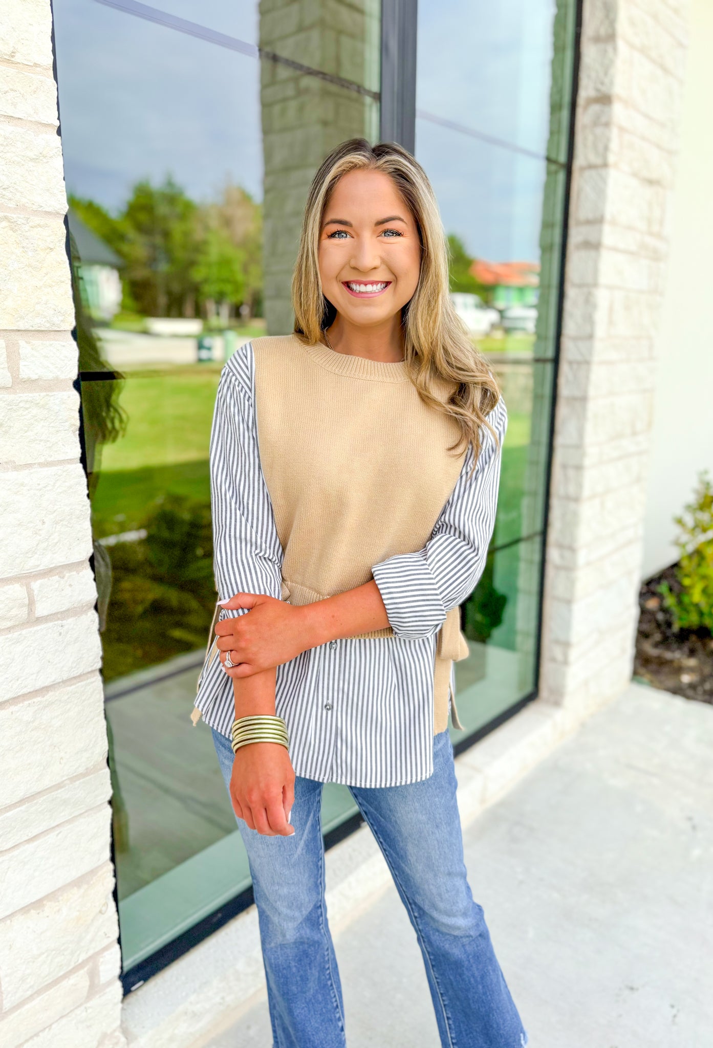 Care To Be Classic Top, grey and white pinstripe button down with camel sweater layered on top, tie details on the side 