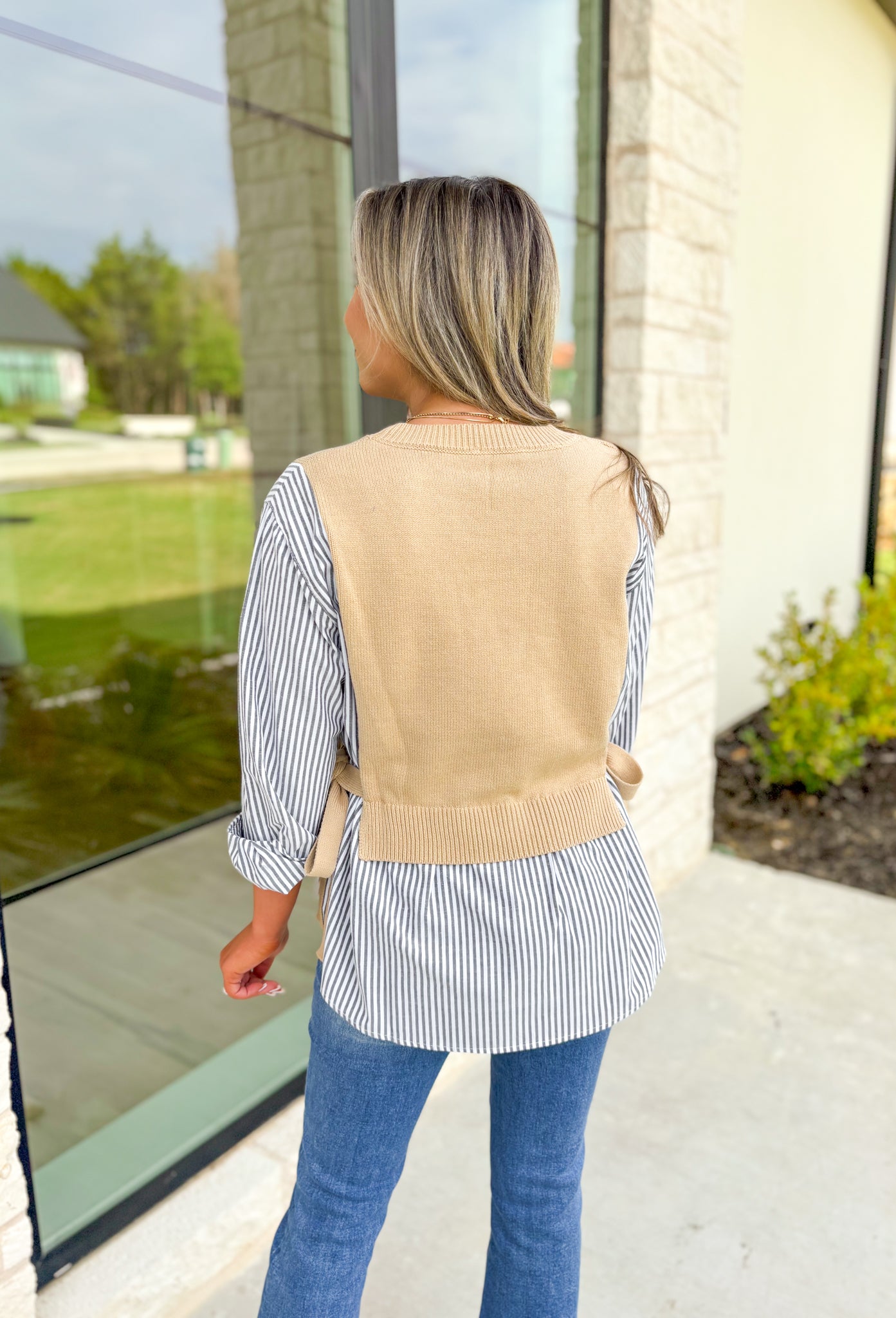 Care To Be Classic Top, grey and white pinstripe button down with camel sweater layered on top, tie details on the side 