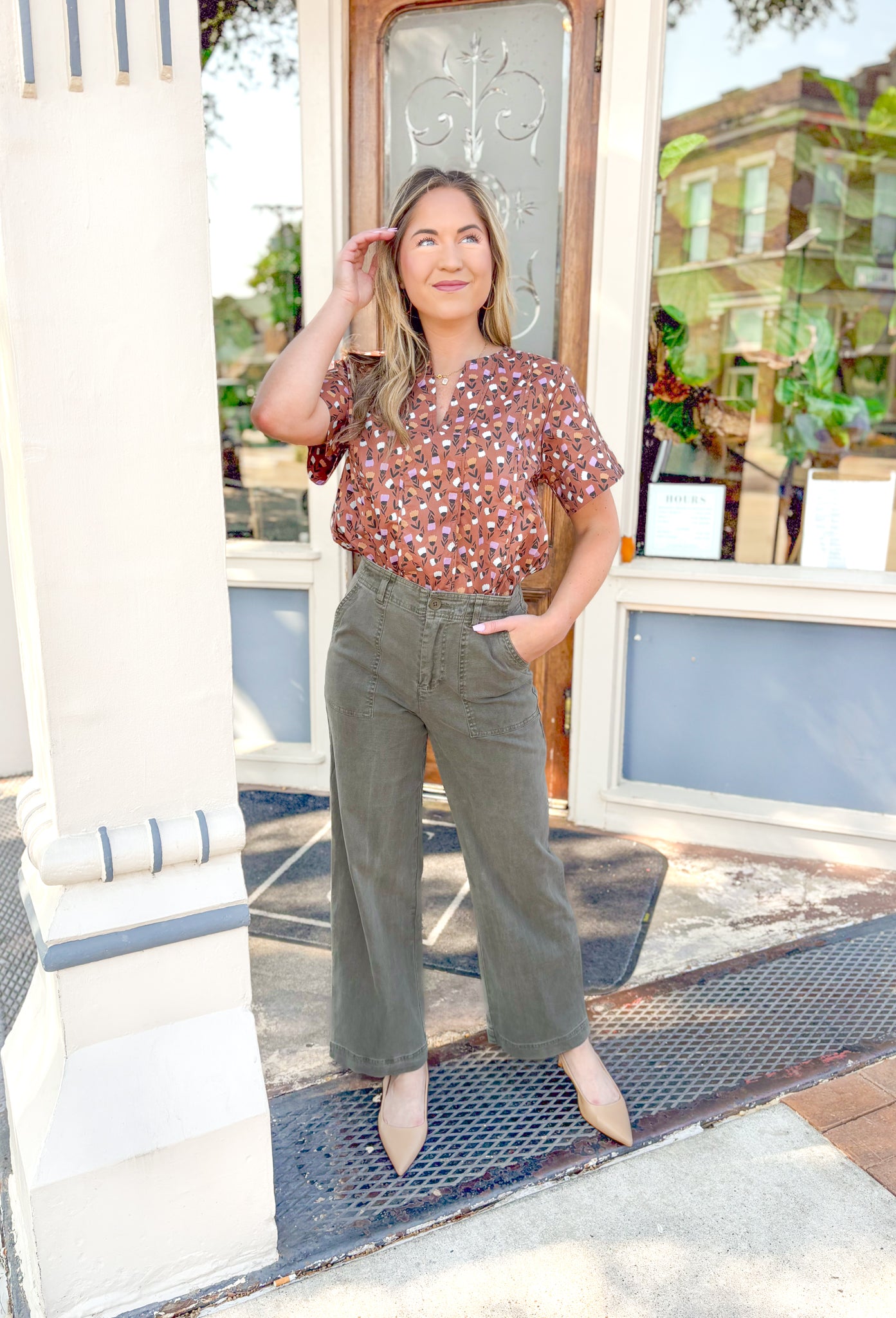 Closer Than Ever Floral Top, warm brown short sleeve blouse with cream, orange, and light purple tulips, blouse has a v-neck line 