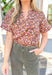 Closer Than Ever Floral Top, warm brown short sleeve blouse with cream, orange, and light purple tulips, blouse has a v-neck line 