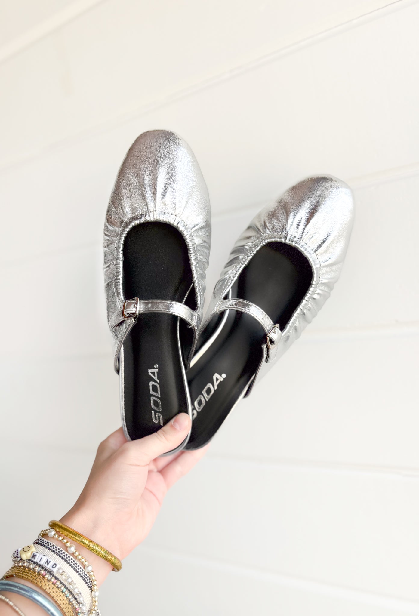 Demure Silver Mules, silver backless ballet flat with rounded toe and strap over the top of the foot