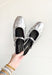 Demure Silver Mules, silver backless ballet flat with rounded toe and strap over the top of the foot