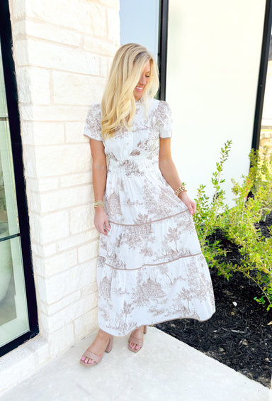 Distant Thoughts Maxi Dress, short sleeve tiered maxi dress in toile print in the colors tan and white, cinching at the waist and tan hem on each tier 