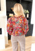 Falling For It Floral Blouse, hot pink, red, orange, cream, teal, and black long sleeve floral blouse with gold tinsel details and a v-neck line 