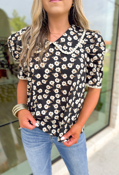 Found My Peace Floral Top, black puff sleeve blouse with white daisy print, mustard details on the floral print, peter pan collar with white scalloping on the hem of the collar and sleeves