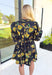 Glimpse Of Us Floral Dress, black, yellow, and green floral quarter button down puff sleeve dress with pleating on the collar and sleeves, tie detail on the back of the dress 