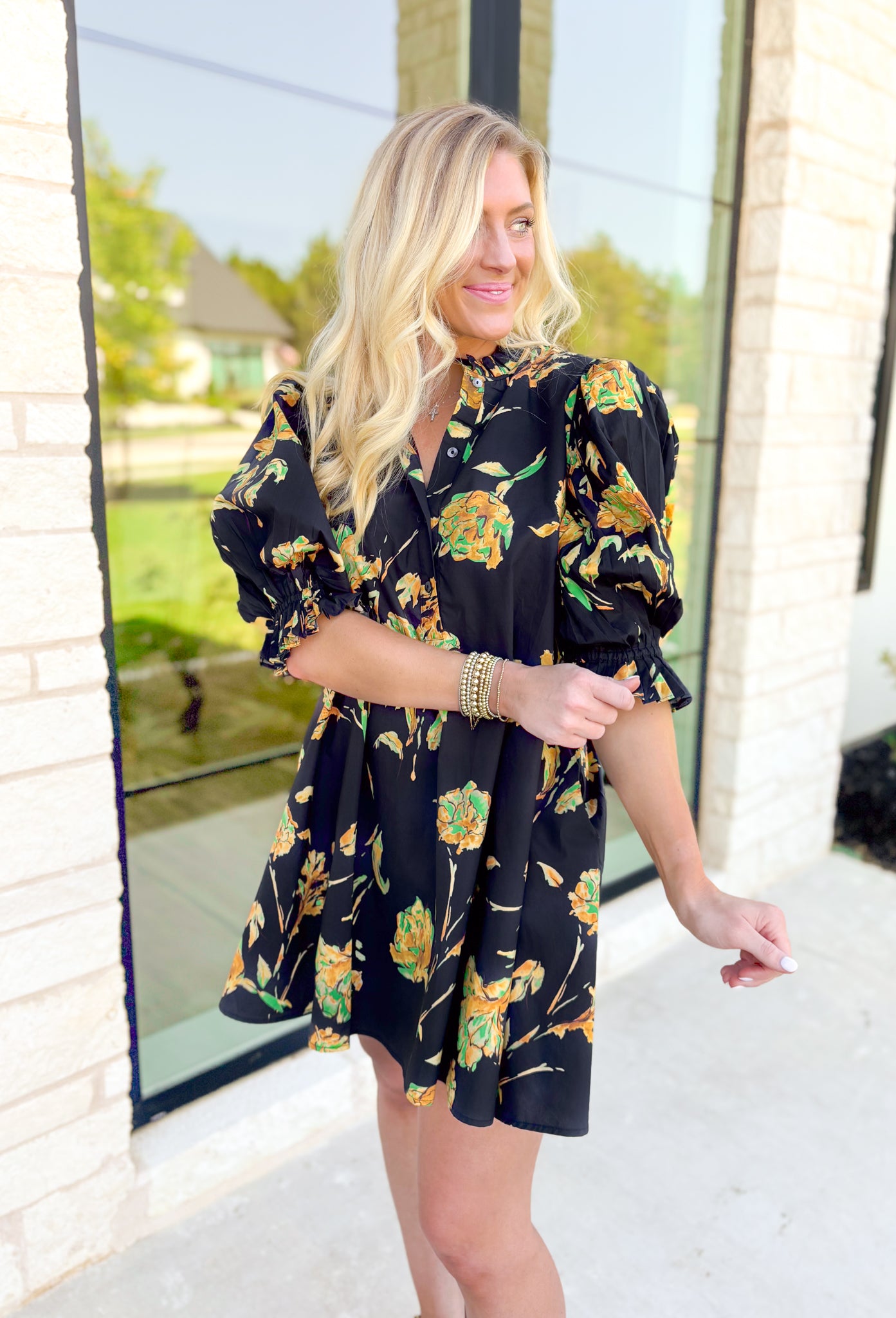 Glimpse Of Us Floral Dress, black, yellow, and green floral quarter button down puff sleeve dress with pleating on the collar and sleeves, tie detail on the back of the dress 