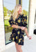 Glimpse Of Us Floral Dress, black, yellow, and green floral quarter button down puff sleeve dress with pleating on the collar and sleeves, tie detail on the back of the dress 