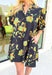 Glimpse Of Us Floral Dress, black, yellow, and green floral quarter button down puff sleeve dress with pleating on the collar and sleeves, tie detail on the back of the dress 