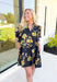 Glimpse Of Us Floral Dress, black, yellow, and green floral quarter button down puff sleeve dress with pleating on the collar and sleeves, tie detail on the back of the dress 