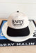 RBF Trucker Hat, black and cream trucker hat with black embroidered text "happy, i just have RBF"