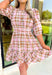 Heading South Plaid Dress, light pink, cognac, and off white plaid puff sleeve mini dress with cinching at the waist with light pink velvet details layered on top of the cinching, tier on the bottom of the dress with ruffle hem detail 