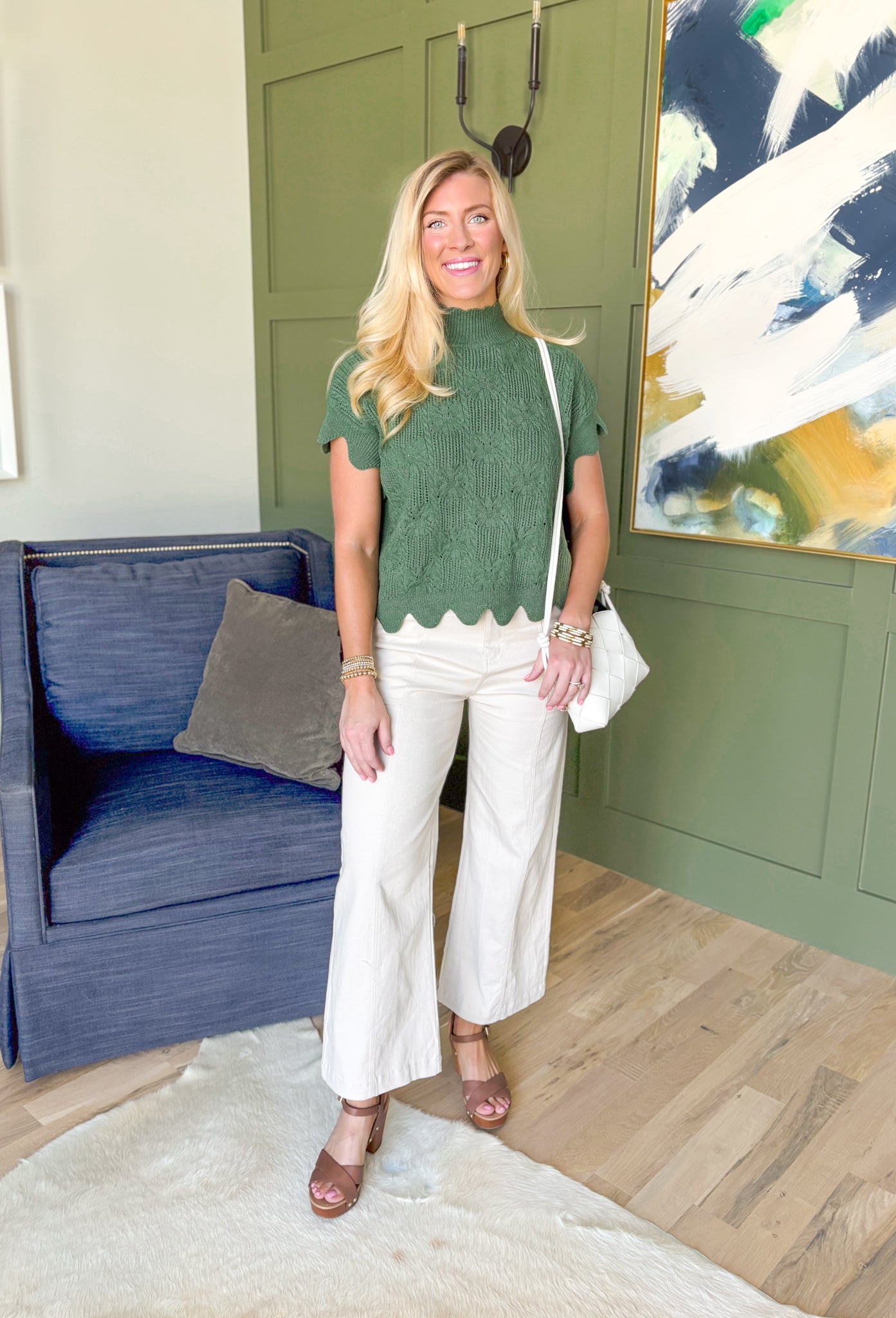 Like A Secret Sweater, short sleeve knit sweater top in fern green, scalloped hemming on the sleeves, high neck, and bottom of the top, black bow detail on the sides of the top 