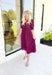 London Calling Midi Dress, wine colored puff sleeve tiered midi dress with cinching on the hem of the sleeves and a v-neck line 