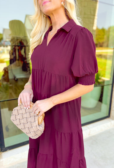 London Calling Midi Dress, wine colored puff sleeve tiered midi dress with cinching on the hem of the sleeves and a v-neck line 