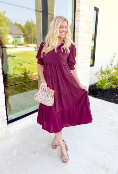 London Calling Midi Dress, wine colored puff sleeve tiered midi dress with cinching on the hem of the sleeves and a v-neck line 