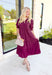 London Calling Midi Dress, wine colored puff sleeve tiered midi dress with cinching on the hem of the sleeves and a v-neck line 