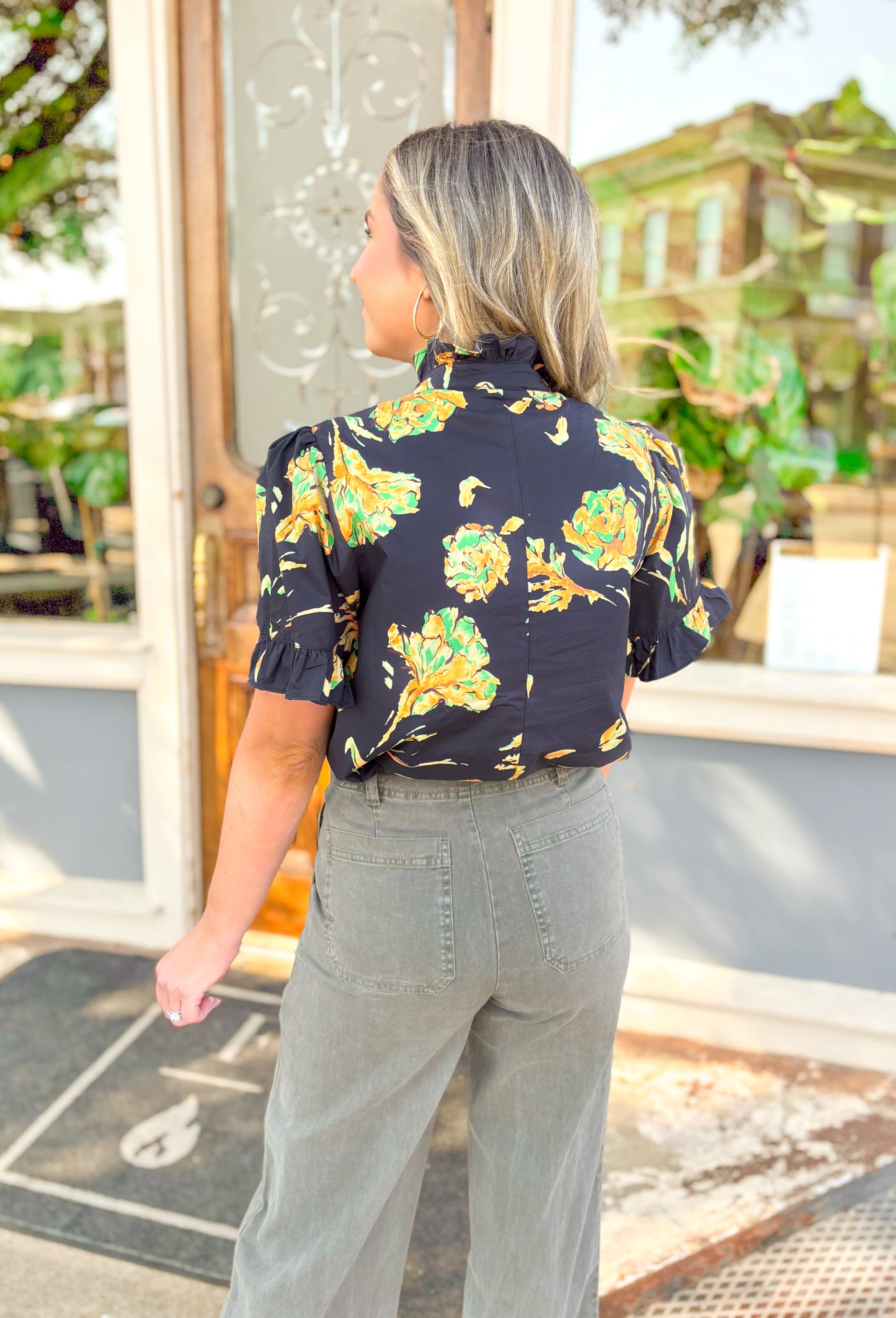 Lost In Time Floral Top, black puff sleeve blouse with ruffling on the hem of the sleeves and neck, quarter button down detail, black blouse with yellow and green floral details 