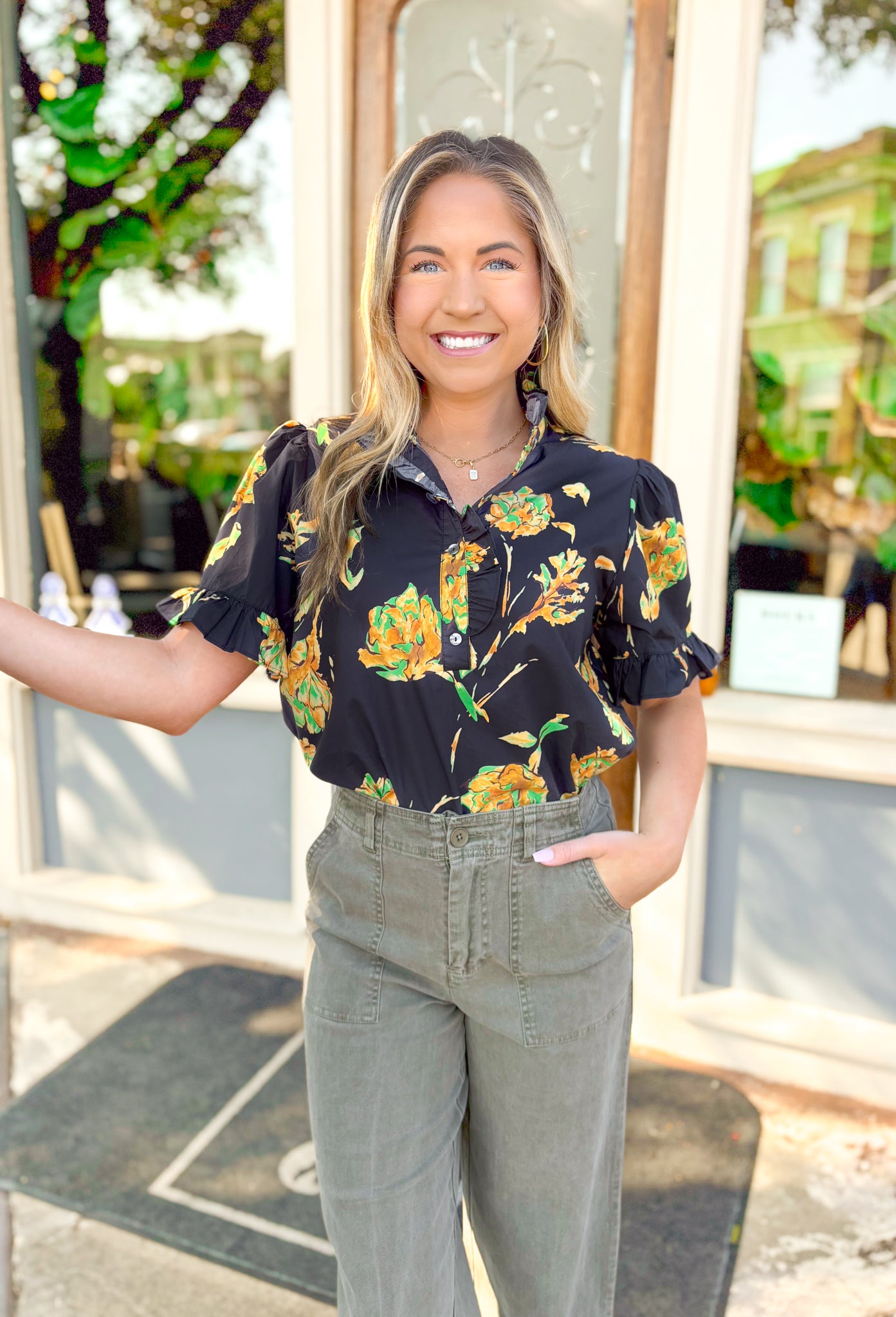 Lost In Time Floral Top, black puff sleeve blouse with ruffling on the hem of the sleeves and neck, quarter button down detail, black blouse with yellow and green floral details 