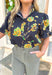 Lost In Time Floral Top, black puff sleeve blouse with ruffling on the hem of the sleeves and neck, quarter button down detail, black blouse with yellow and green floral details 