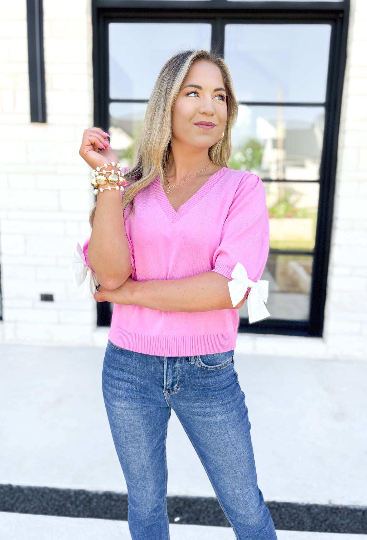 Mind Is Made Up Top, bubble gum pink short sleeve knit top with soft v-neck and white bows on the sleeves 