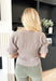 My Wishes Sweater in Mocha, taupe knit short sleeve top with ribbing on the body of the top and a slight flutter detail on the hem of the sleeve 