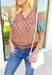 Nothing Has Changed Top, short puff sleeve blouse with v-neck line that has ruffles lining it, abstract print in the colors orange, periwinkle, cream, grey, and turquoise. Turquoise lace details on the puff sleeves 