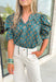 Off The Record Floral Top, blue green puff sleeve blouse with v-neckline, yellow and tan floral detail, lace on the neck line, around the collar, and on the hem of the sleeves 