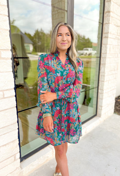 Romantic Bliss Floral Dress, blue green long sleeve button down dress with palm leaf and floral detail in the colors light pink, magenta, fuchsia, turquoise, and mustard 