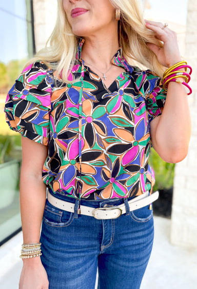 Secret Message Floral Blouse, black, pink, orange, green, blue, and brown floral puff sleeve blouse with ruffling on the neck 