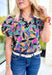 Secret Message Floral Blouse, black, pink, orange, green, blue, and brown floral puff sleeve blouse with ruffling on the neck 