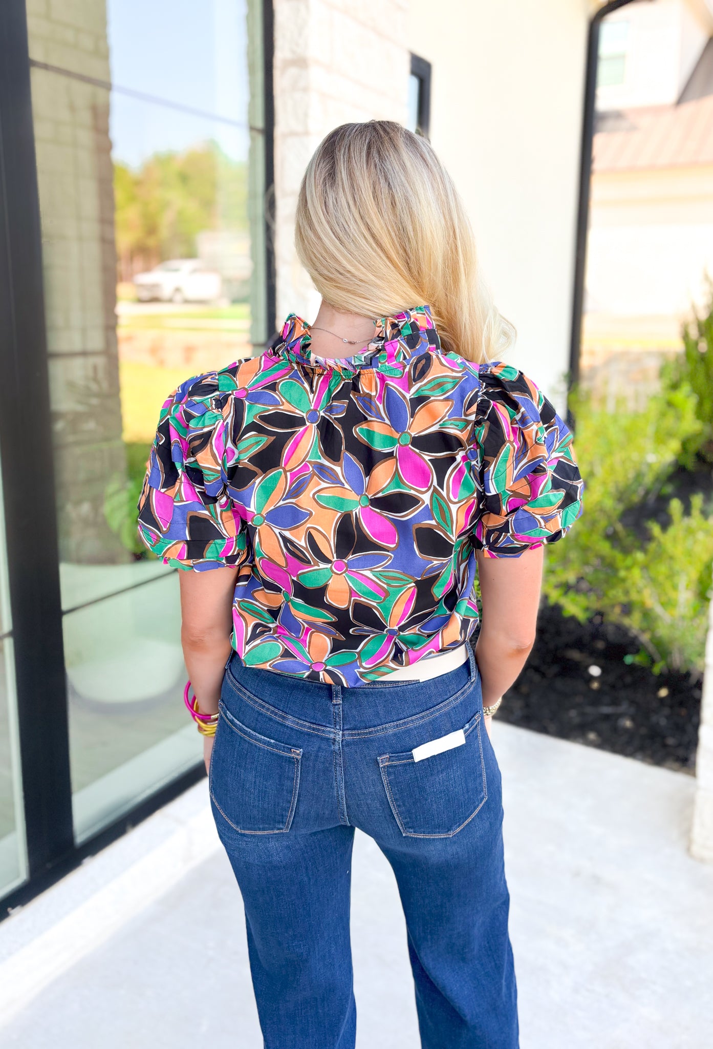 Secret Message Floral Blouse, black, pink, orange, green, blue, and brown floral puff sleeve blouse with ruffling on the neck 