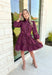 Simply Chic Dress in Merlot, long sleeve pearl button down dress with eyelet lace details on the body, tiers and sleeves of the dress, tie belt detail around the waist, scallop lace detail on the hem of the dress as well as the collar 