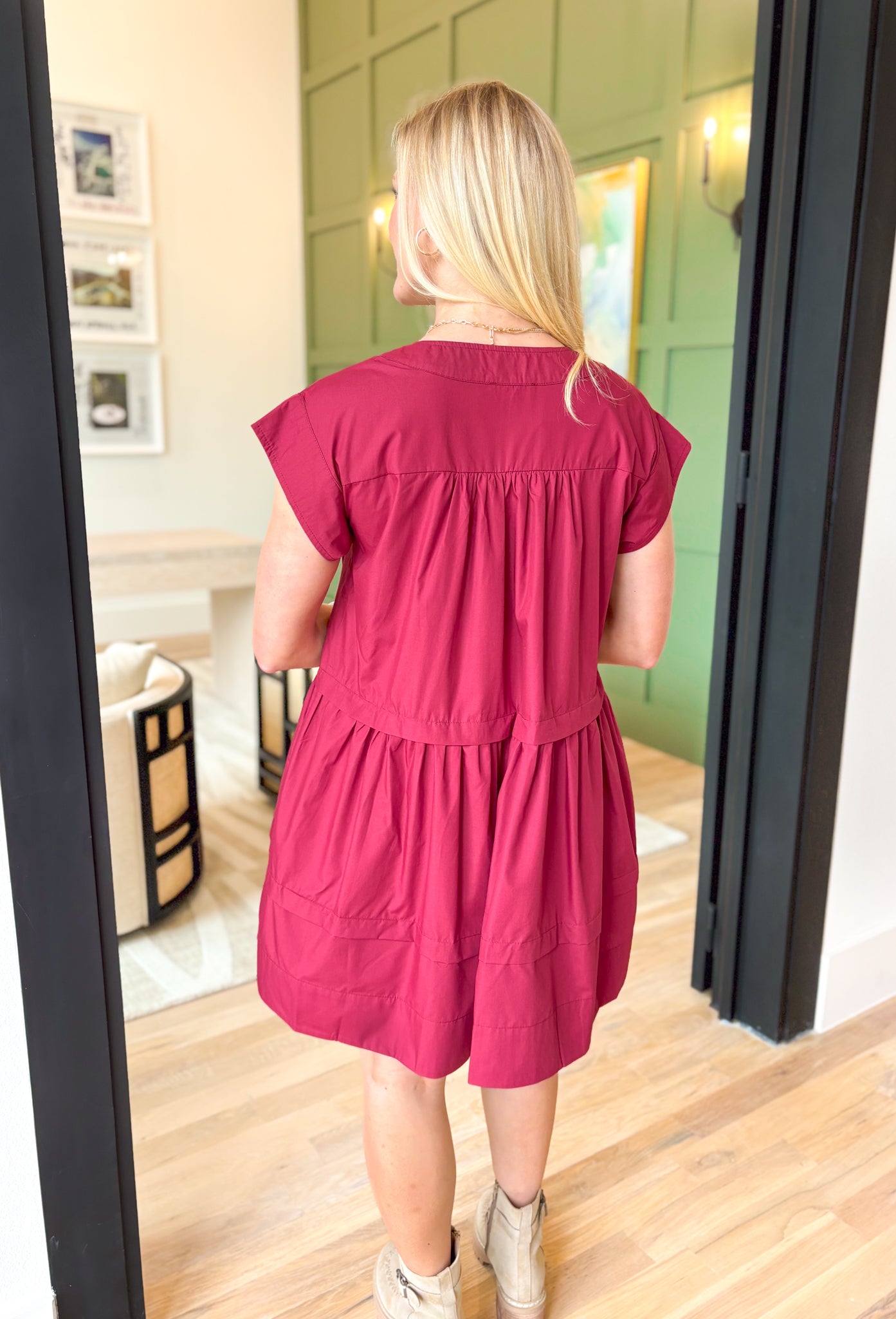 Steal A Kiss Dress, burgundy cap sleeve babydoll mini dress with tiers, pleating across the chest, and wrapped buttons going a quarters length down the front of the dress, v-neck line, pockets 